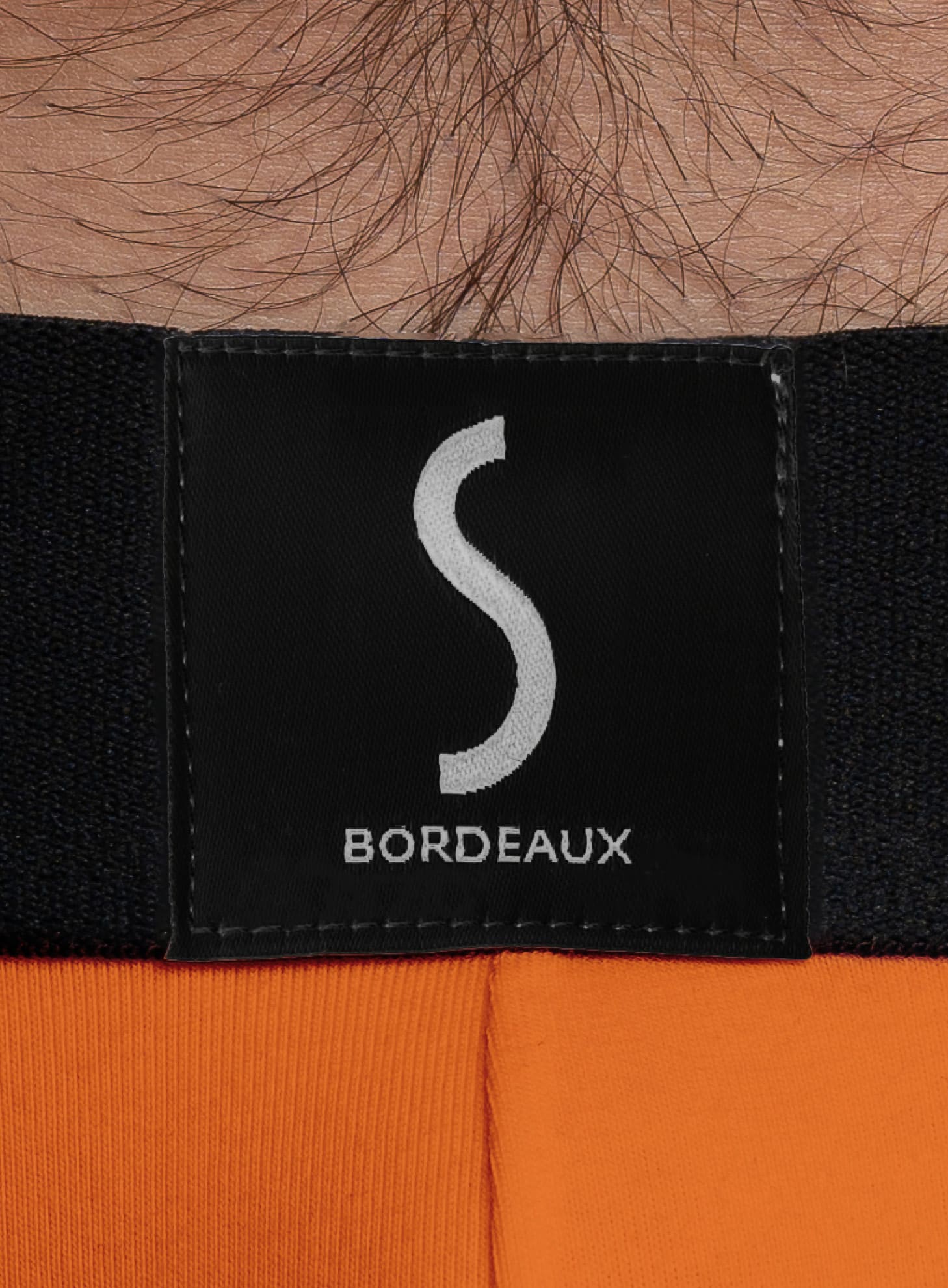 mannequin homme portant un Slip orange pour homme aumale de la marque S BORDEAUX